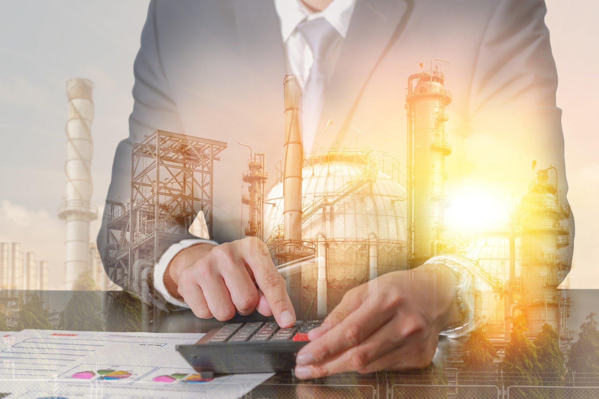 businessman working with calculator, fuel, Electric generating factory with sunset